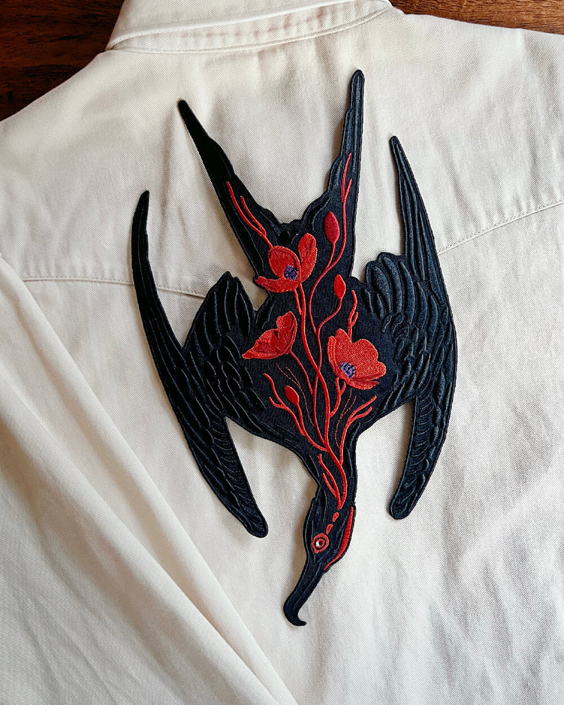 Black and red floral design patch on a white shirt