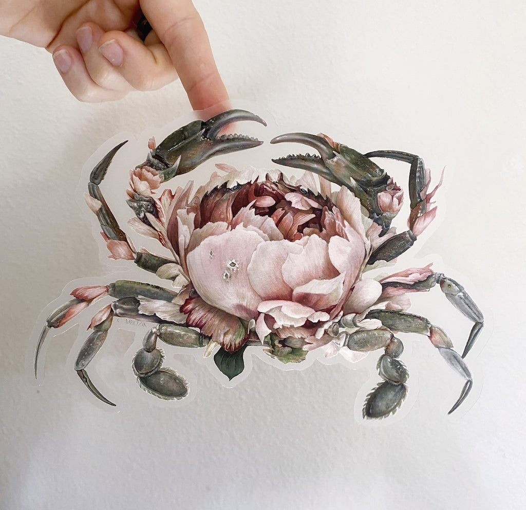 Large clear-backed sticker of a gray crab with a large pink peony for a shell.