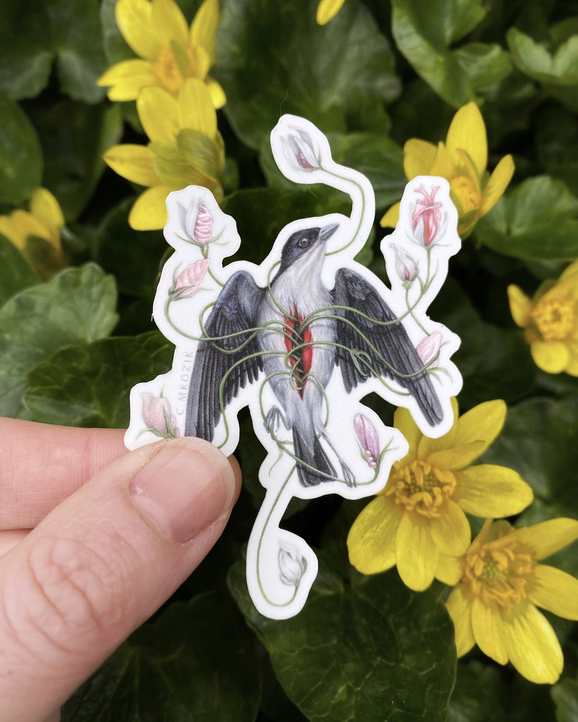 A small sticker of a gray flowerpecker with pink flowers growing from its chest.