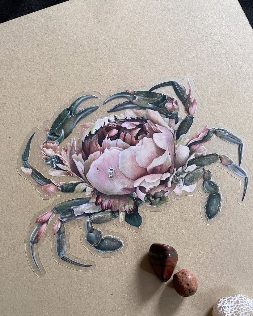 Large clear-backed sticker of a gray crab with a large pink peony for a shell.