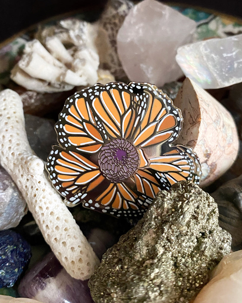 Small enamel pin of an orange California poppy made of monarch butterfly wings.