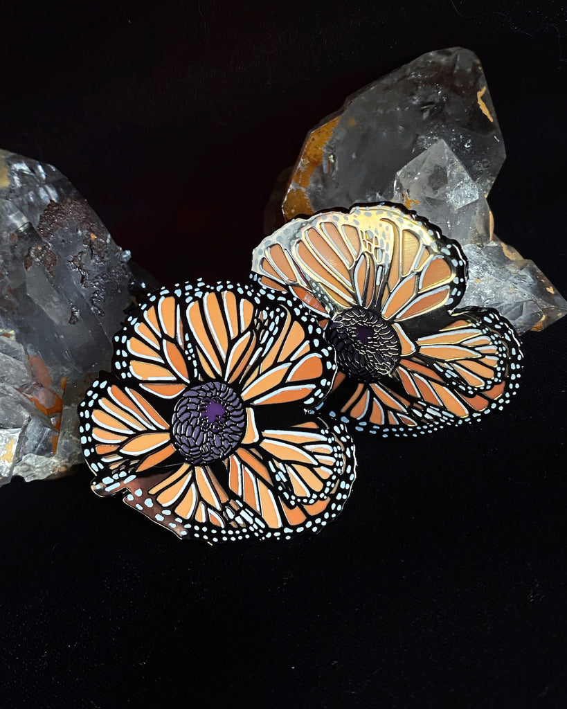 Small enamel pin of an orange California poppy made of monarch butterfly wings.