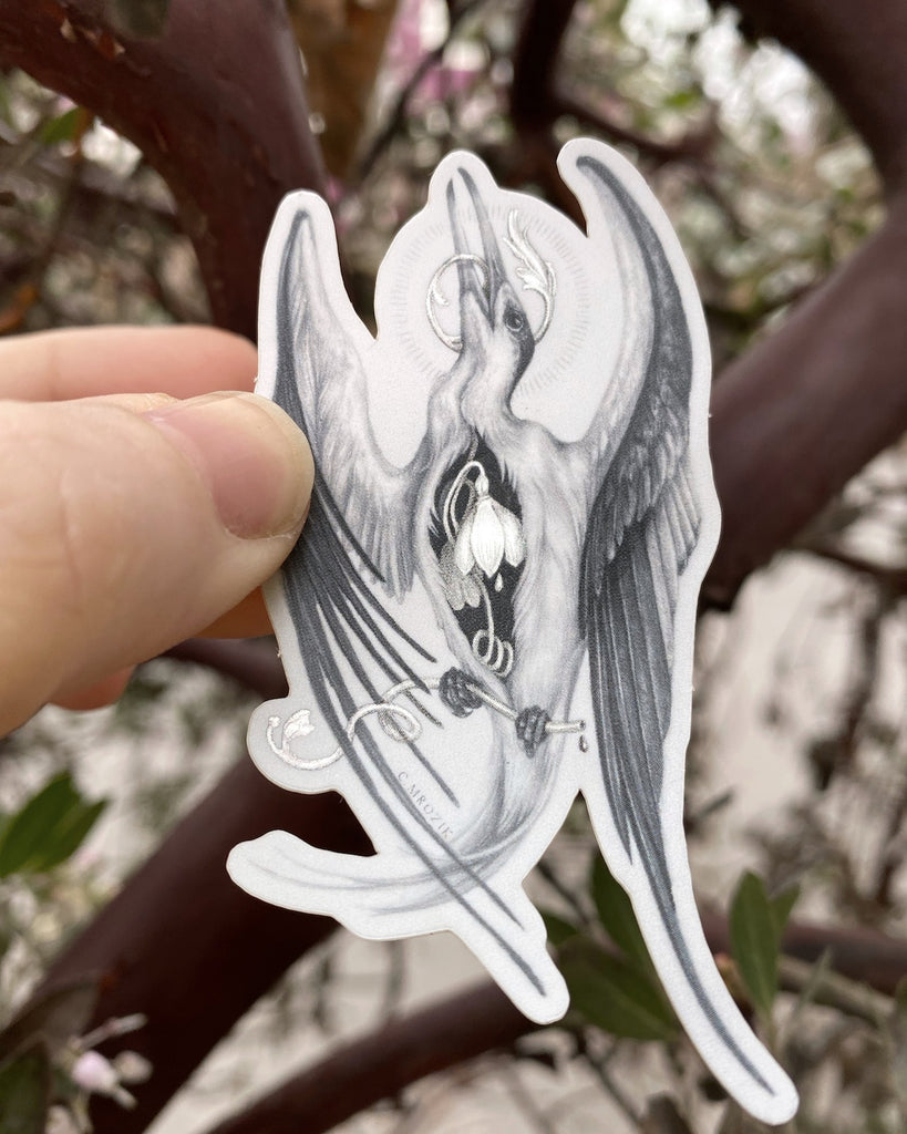 Small matte sticker with a graphite drawing of a white tern with a holographic snowdrop flower in its chest.