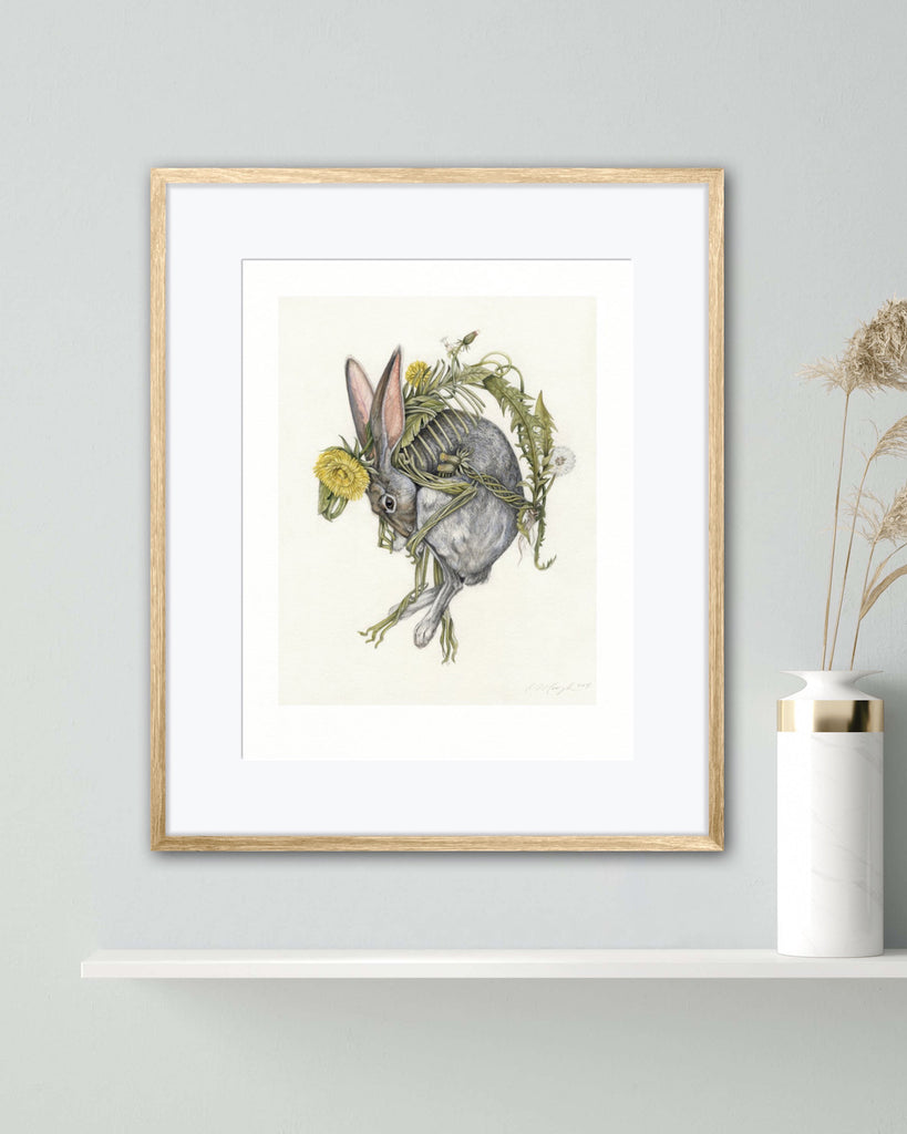 Art print of a gray rabbit curled around intertwining dandelion flowers on a cream background.