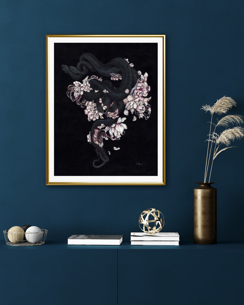 Art print of two black snakes on a bed of pink flower petals with black background.